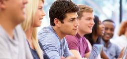 close up of a male student listening in a classroom